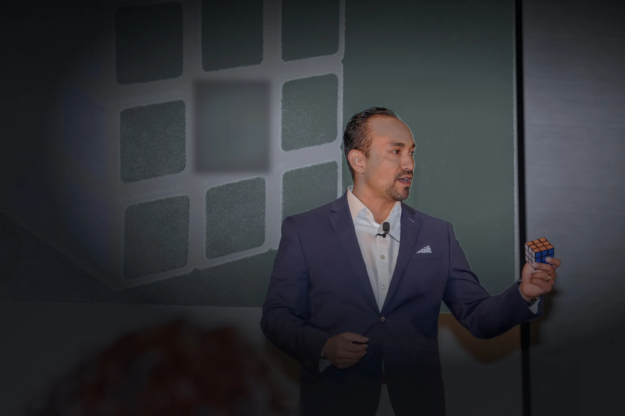 Juan P. Ortega teaching on stage with a Rubik's cube in Honolulu, 2022