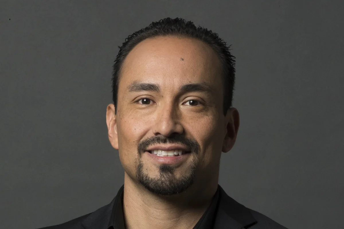 Juan P. Ortega, keynote speaker, forward-facing headshot in a dark blazer